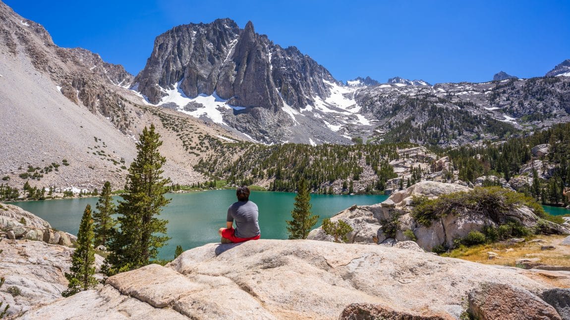 Hiker overlooking the mountains and lake 