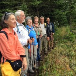 A group of hikers pose in a line in Isle Royale National Park