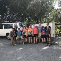 Group of bikers in front of a white van