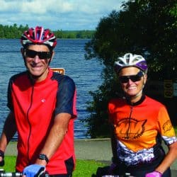 cyclists in front of a lake
