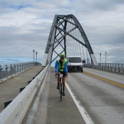 Biker biking over a bridge in Maine