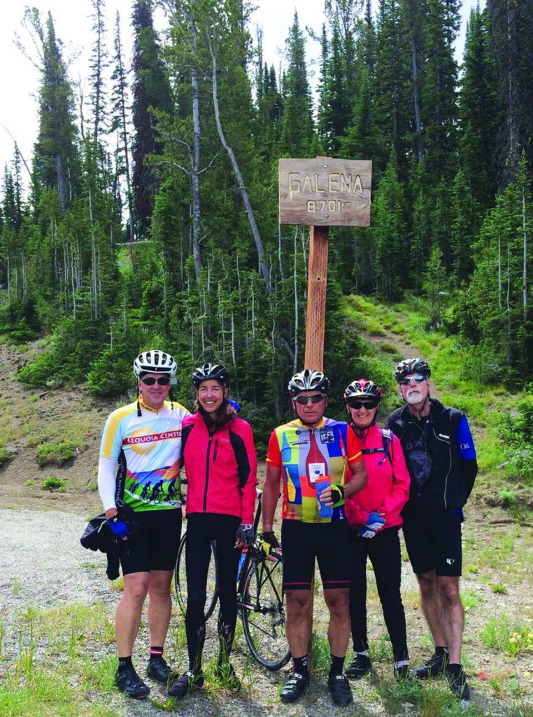 Happy cyclists at the top of Galena Pass in Sawtooth Mountains, Idaho