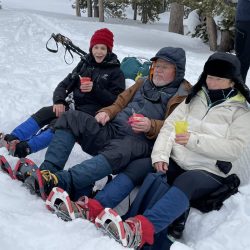 3 people resting during snowshoeing in Yellowstone