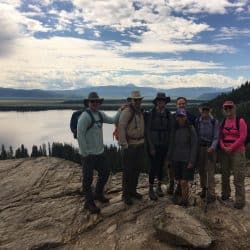 A group poses in front a lake in Yellowstone