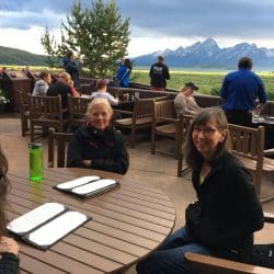 Two women on a tour sit at a table in Grand Teton National Park
