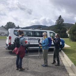 group of hikers in front of a white van in Yellowstone