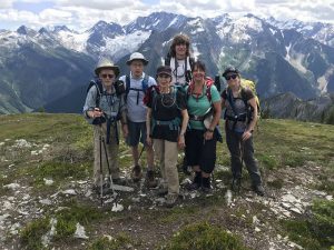 group of hikers layering clothing for spring hike