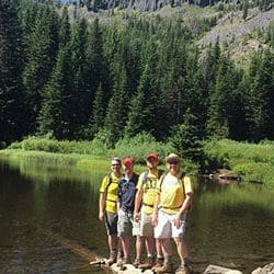 hikers in front of a lake