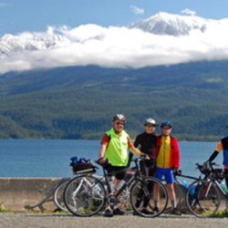 Bikers in front of a lake in the Selkirk - Kootenay Mountains