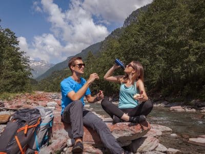 couple having lunch on river