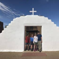 Hikers in front of a religious landmark