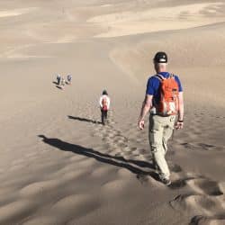 Hikers on sand dunes in Santa Fe